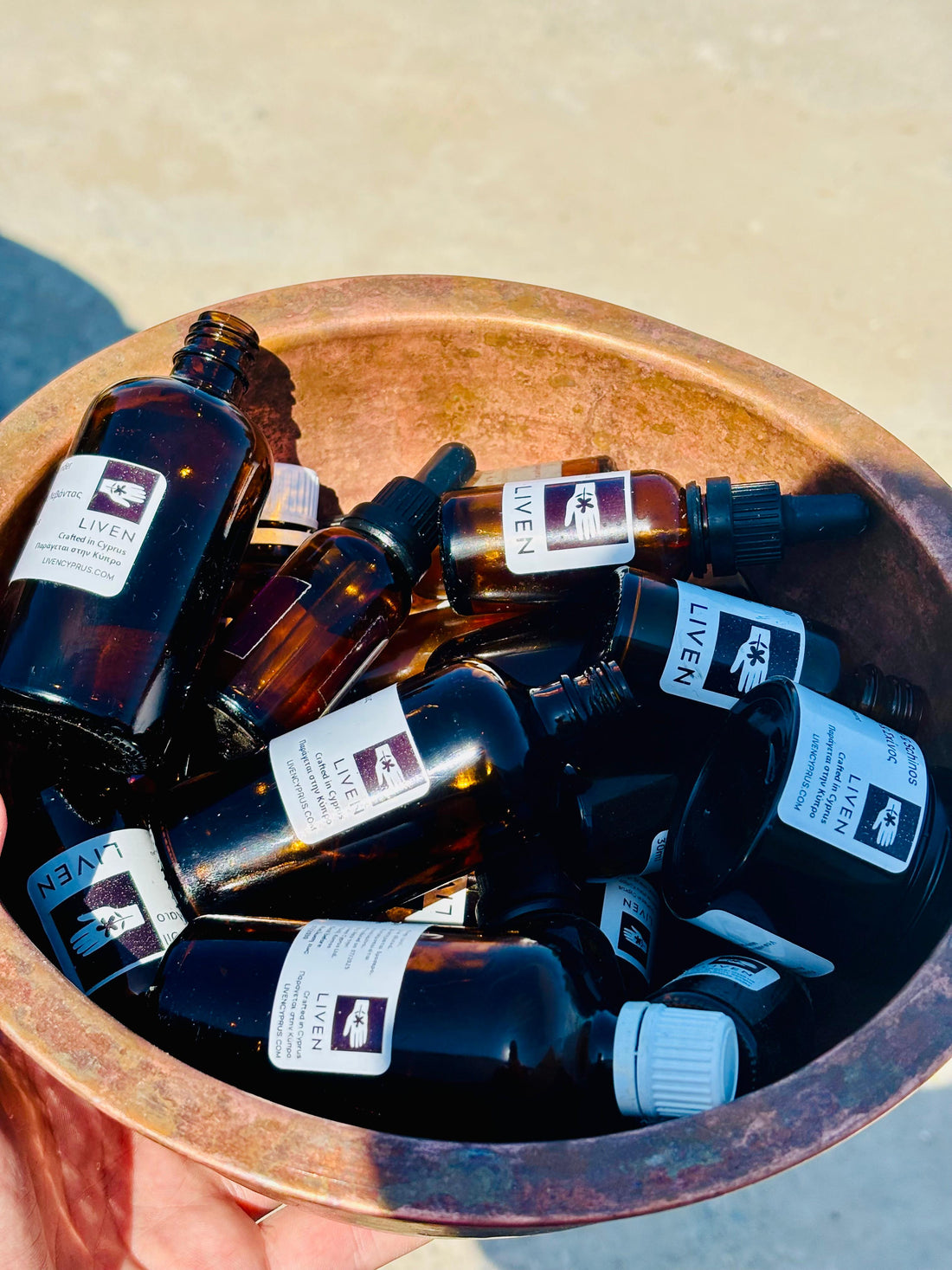 used amber glass bottles with liven labels ready to be washed 