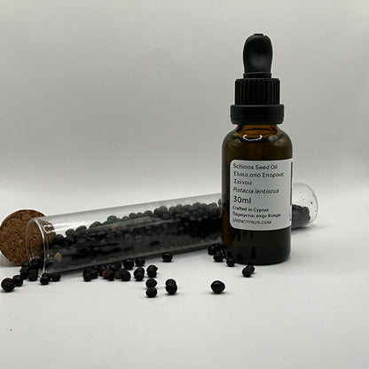 Bottle of mastic seed oil with a dropper and scattered seeds