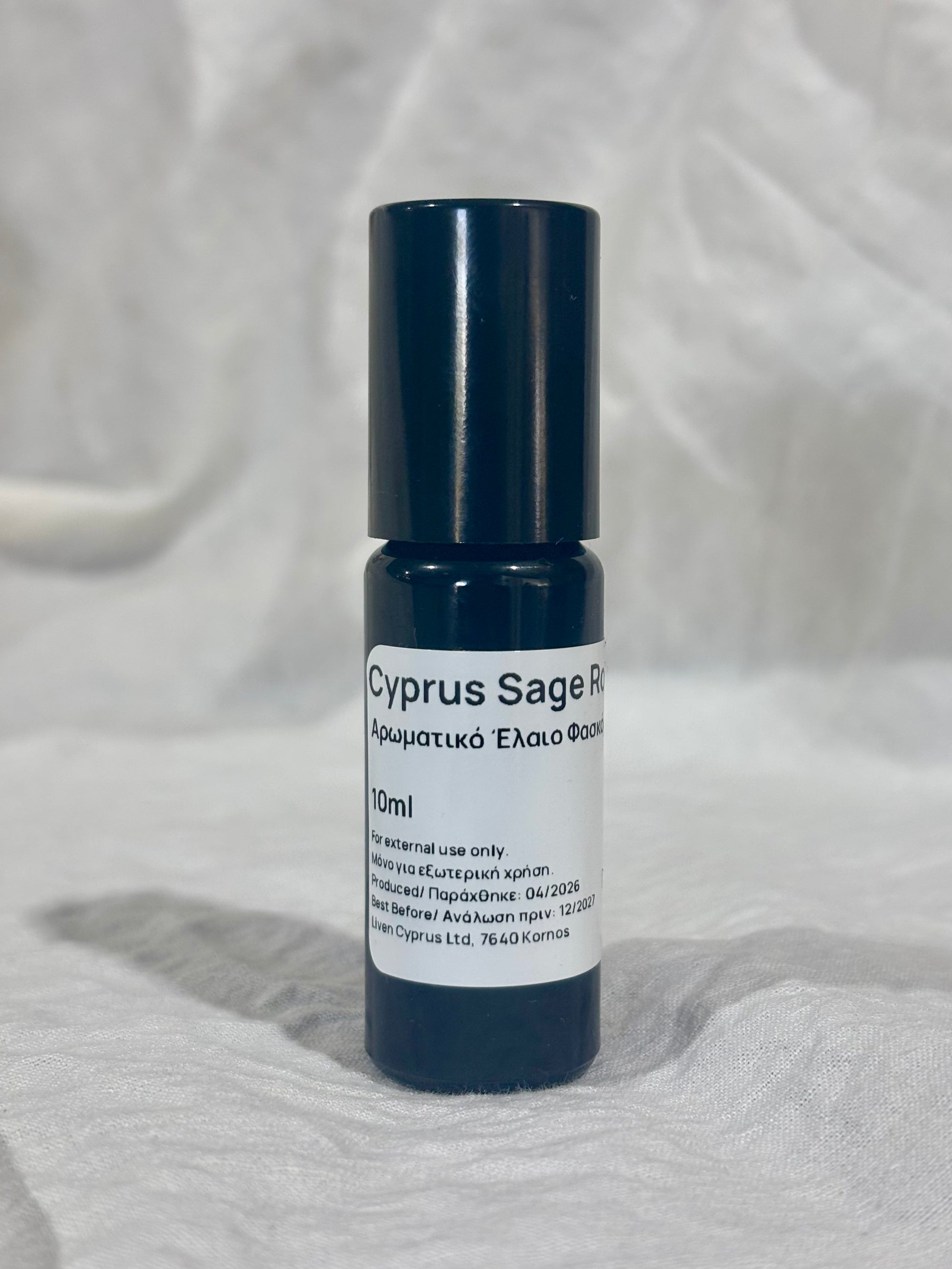 Roll-on bottle labeled 'Cyprus Sage' on a textured white background