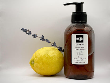 Brown bottle of LIVEN liquid soap with a lemon and lavender sprig on a light background