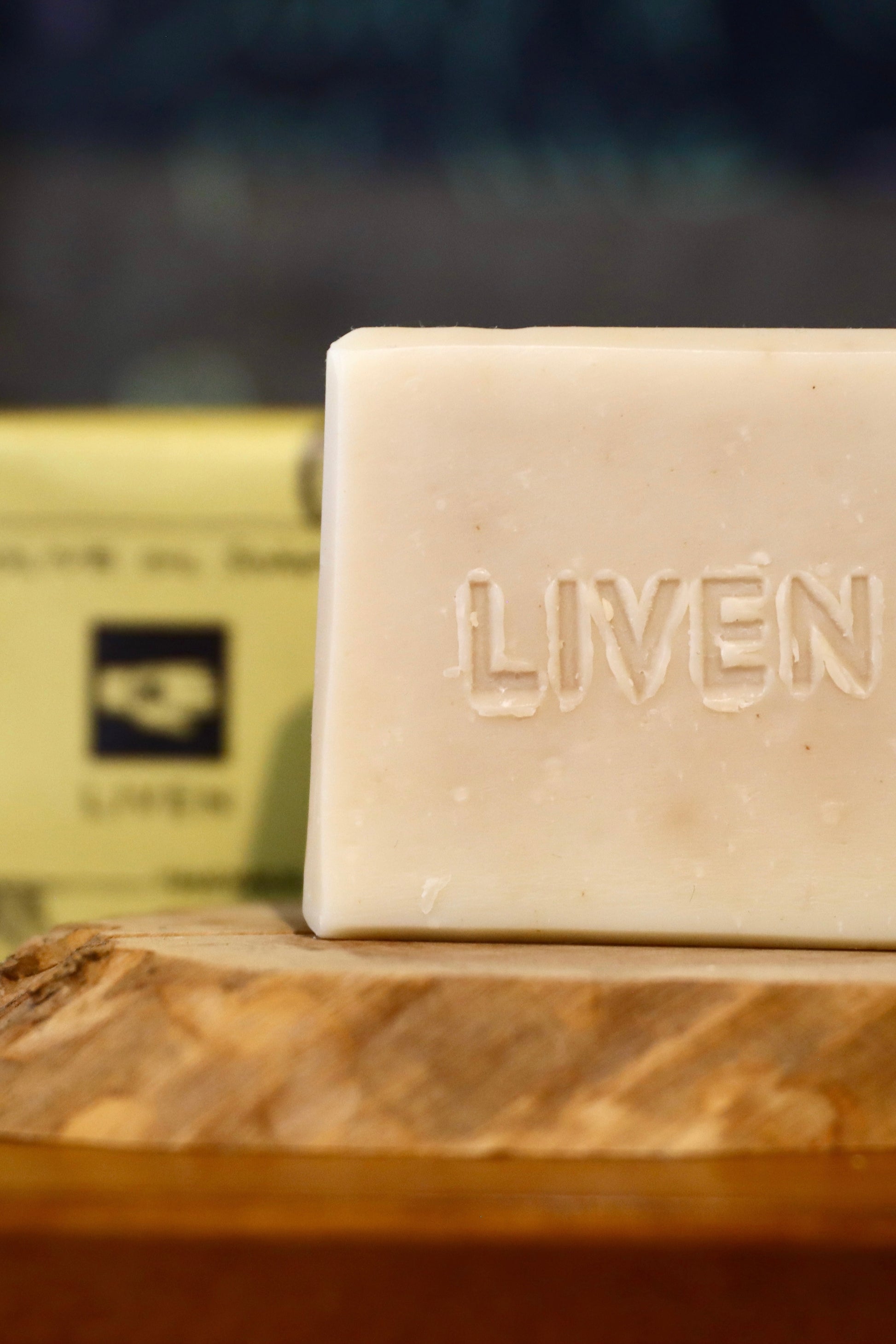 Bar of soap with 'LIVEN' branding on a wooden surface