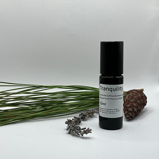 Roll-on bottle labeled 'Tranquility' with lavender and pine branches on a white background