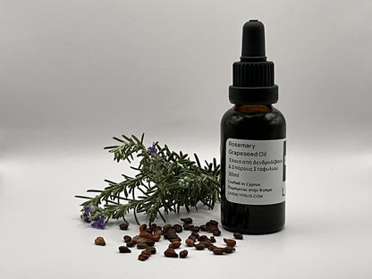 Bottle of rosemary grapeseed oil with a dropper and rosemary sprig on a gray background