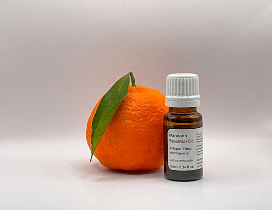 Mandarin essential oil bottle with a cyprus mandarin fruit 