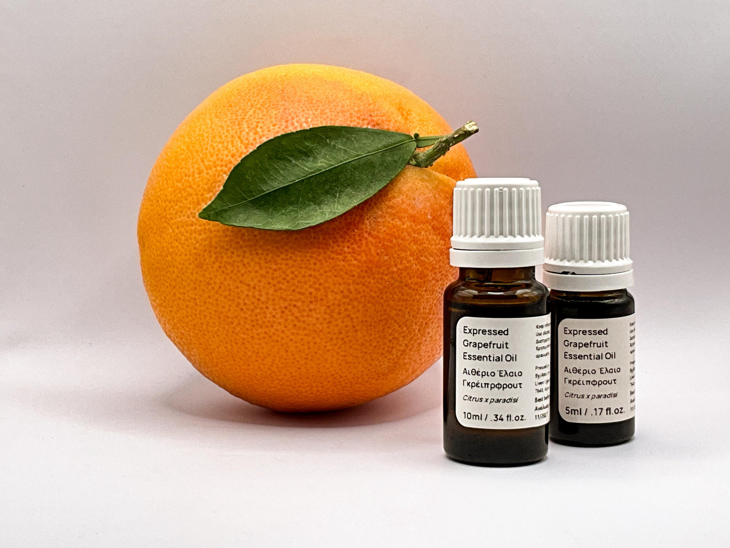 grapefruit essential oil next to real fruit