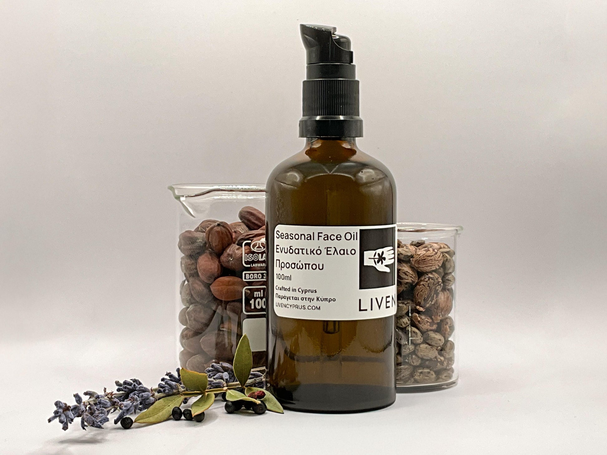Bottle of Liven seasonal face oil with glass containers of Cyprus seeds and nuts 